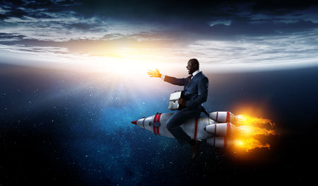 Businessman on a rocket. Mixed mediaの写真素材