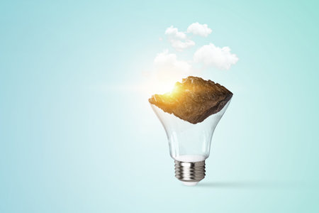 Mountain inside light bulb. Mixed media contentの写真素材