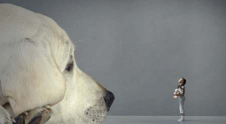 Little girl and giant dogの写真素材