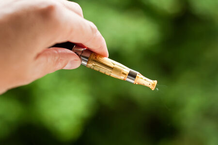 e-cigarette with hand closeup in outdoor