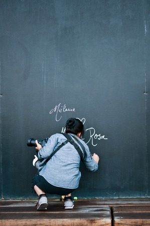 woman writing on big blackboardの写真素材