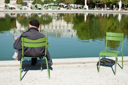 man reading in Tuileries garden in Parisの写真素材