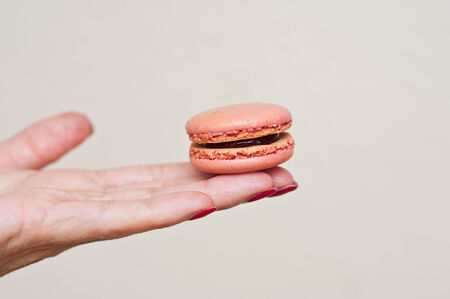 Woman\'s hand with  macaronの写真素材