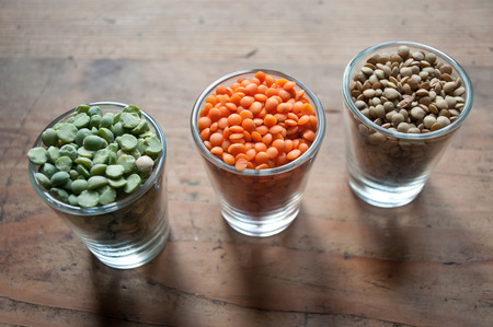 lentils and split peas on wooden background