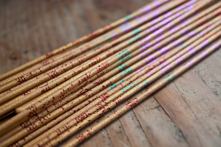 asian incense closeup on wooden backgroundの写真素材