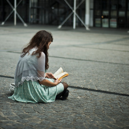 PARIS - France - 7 august 2012 - woman sitting with book in Beaubourg placeのeditorial素材
