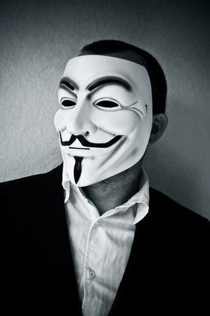 PARIS - France - 22 April 2015 - man wearing suit businessman and Vendetta mask. This mask is a well-known symbol for the on line hacktivist group Anonymousのeditorial素材