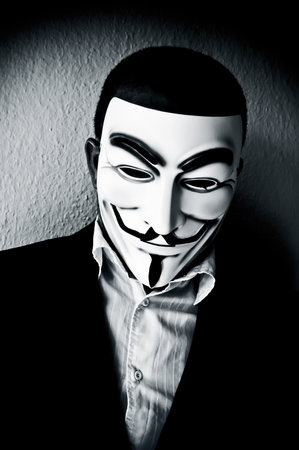 PARIS - France - 22 April 2015 - man wearing suit businessman and Vendetta mask. This mask is a well-known symbol for the on line hacktivist group Anonymousのeditorial素材