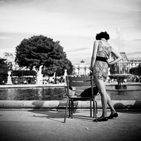 PARIS  France  14 August 2012  woman with dress standing near chair in Tuilerie garden in Parisのeditorial素材