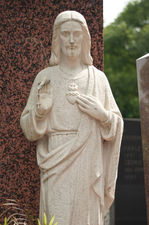 stoned christ  statue in cemeteryの写真素材