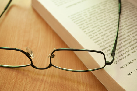 glasses on a book closeupの写真素材