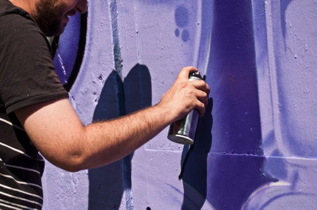 MULHOUSE  France  07 June 2015  closeup hand of painter during the BOZAR  graffiti festival  quay of sinners in Mulhouseのeditorial素材