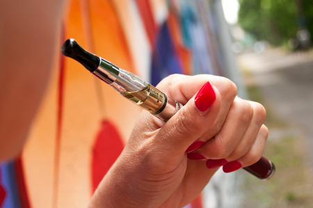 closeup woman with e-cigaretteの写真素材