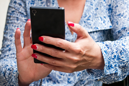 closeup hand of woman with smartphoneの写真素材