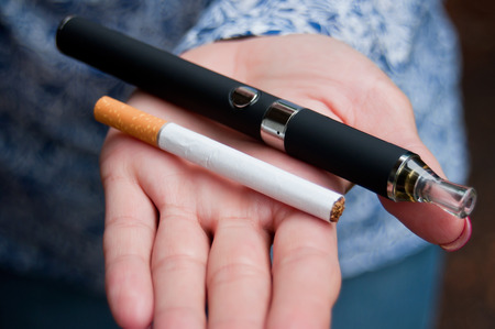 closeup hand of woman with e-cigaretteの写真素材