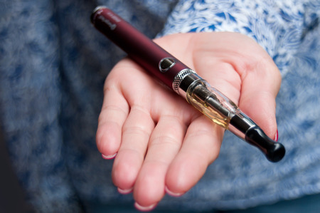 closeup hand of woman with e-cigaretteの写真素材