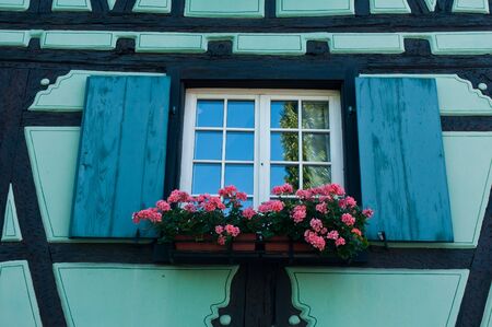 closeup blue window in Colmar with flowersの写真素材