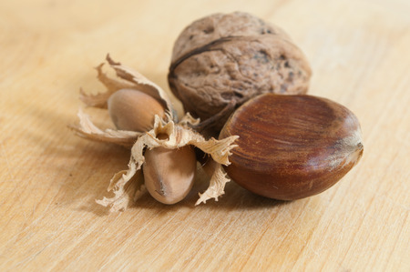 group of chestnuts nuts and walnuts on wooden backgroundの写真素材