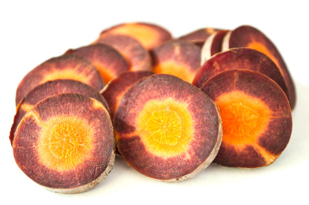 closeup of sliced violet carrots on white backgroundの写真素材