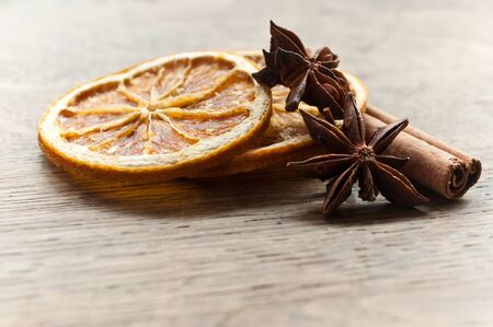 closeup of sliced orange with  dried anise and cinnamonの写真素材