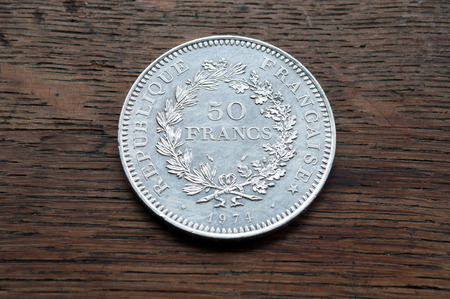silver coin of 50 francs hercule french collecting money on wooden background
