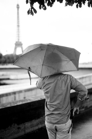 PARIS - france - 7 July 2012 - quay of Seine river by a rainy day with Eiffel tower backgroundの写真素材