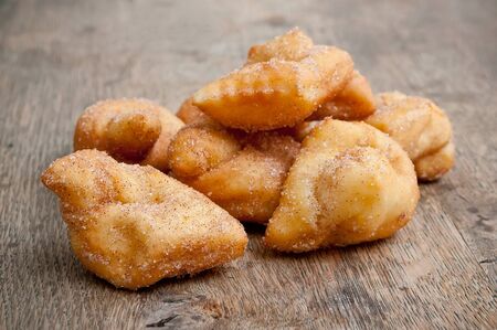 Bugne - french donut on wooden background