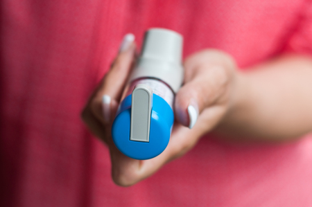 closeup of hand with asthma aerosolの写真素材