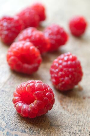 closeup of group of raspberries   on wooden table backgroundの写真素材
