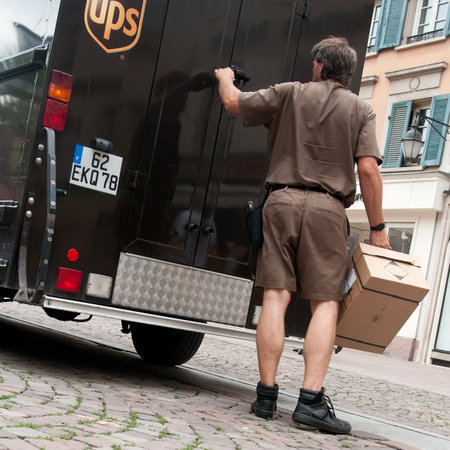 MULHOUSE - France - 2 August 2016 - UPS truck and delivery manのeditorial素材