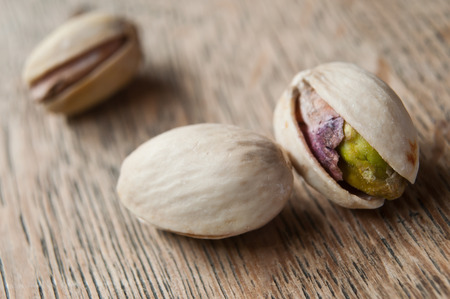 closeup of pistachios on wooden backgroundの写真素材