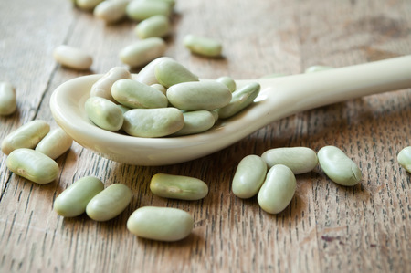 closeup of dried beans  in a spoon on wooden backgroundの写真素材
