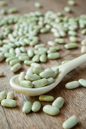 closeup of dried beans  in a spoon on wooden backgroundの写真素材