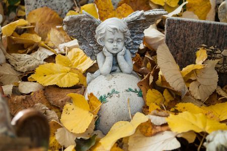 white angel in cemetery on a tombの写真素材