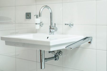 closeup of sanitary with with chromium faucet and white bathroom sinkの写真素材