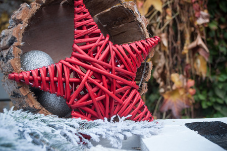 closeup of red wooden star in a christmas treeの写真素材