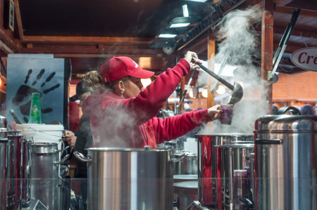 Mulhouse - France - 8 December 2016 - woman giving mulled wine at the christmas market