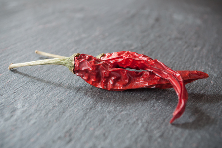 closeup of red hot peppers on chalkboard  backgroundの写真素材