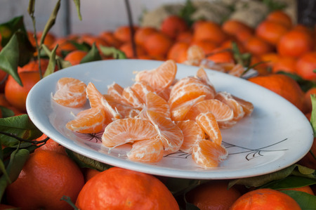 closeup of tasting tangerine at the market の写真素材