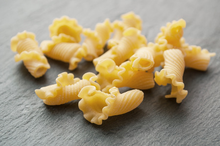 closeup of group of corolla pasta on chalkboard background の写真素材