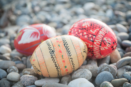 closeup of decorative easter eggs in outdoor in the gravelの写真素材