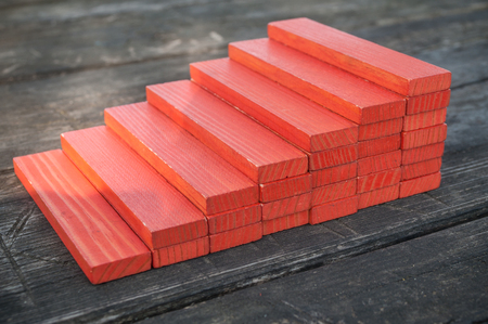 closeup of wooden stair in red wooden bricks on wooden backgroundの写真素材