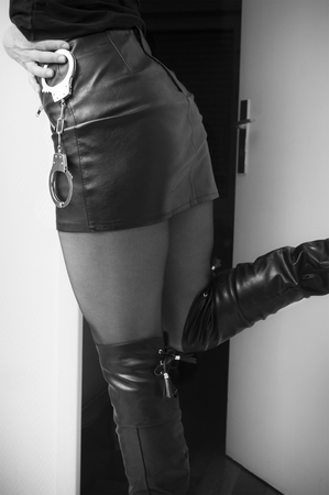 closeup of sexy woman with leather skirt and Handcuffs の写真素材