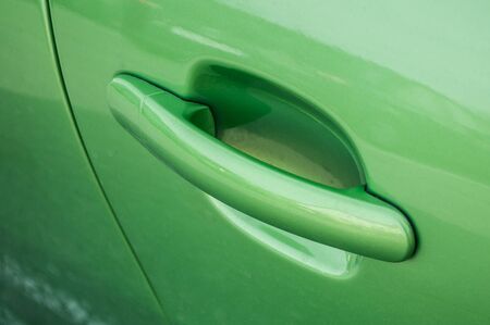 closeup of modern handle of green carの写真素材