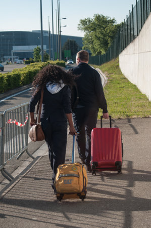 BASEL - Switzerland - 5 MAY 2017 - couple of tourists walking with a suitcase  in the airportのeditorial素材