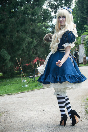 WESSERLING - France - 21 May 2017 - woman with blue dress like Alice in wonderland by Sakizou japanese artist in park way at cosplay exhibition eventのeditorial素材