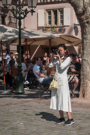 STRASBOURG - France - 25 May 2017 - portrait  of asian tourist taking picture on place  with terrace bar in Strasbourgのeditorial素材