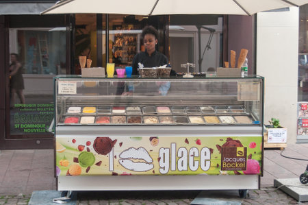 MULHOUSE - France - 2 June 2017 - young black woman waiting customer at Jacques Bockel the french ice cream merchant in the street of Mulhouseのeditorial素材