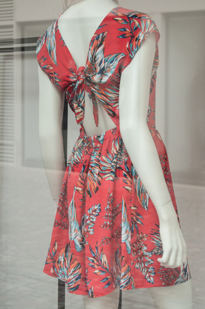 closeup of mannequin with backless dress in a fashion store for women