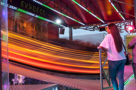 MULHOUSE - France - 28 July 2017 - woman waiting illuminations in attraction parkのeditorial素材